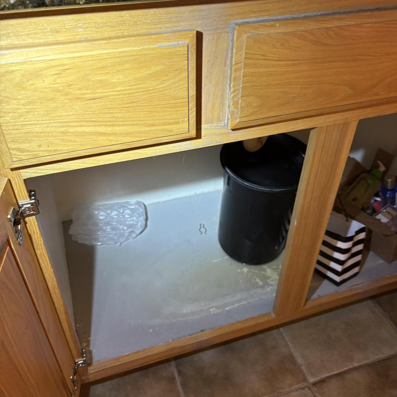 Kitchen cabinet under sink with plumbing access removed