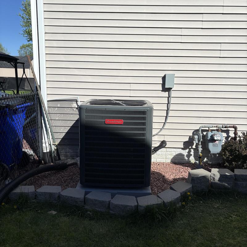Goodman central AC unit installed outside house