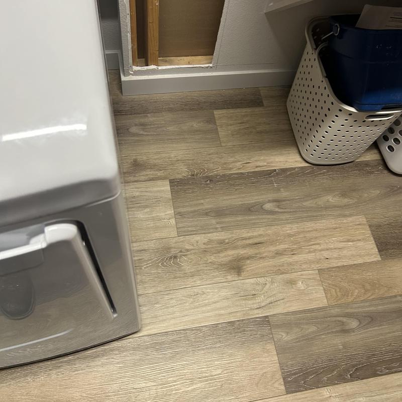 Laundry room wall with exposed plumbing cavity