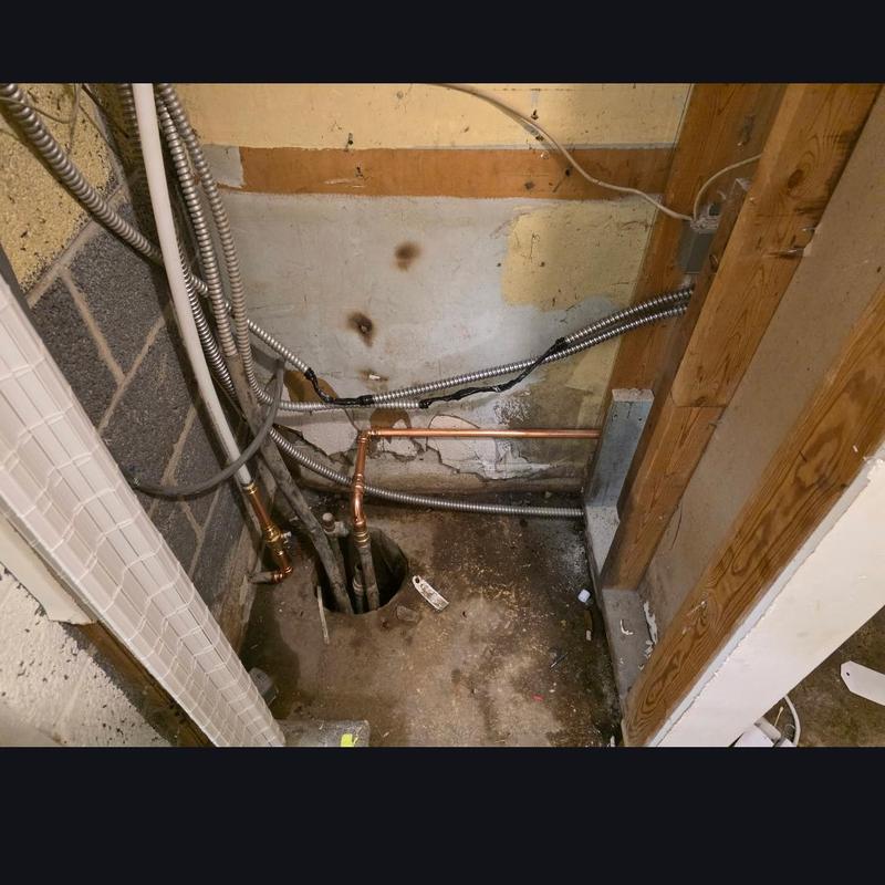 Well piping and bladder tank installation in basement corner