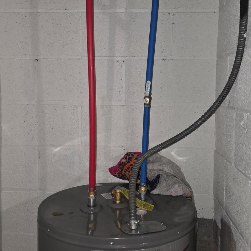 Bladder tank with red and blue water pipes installed