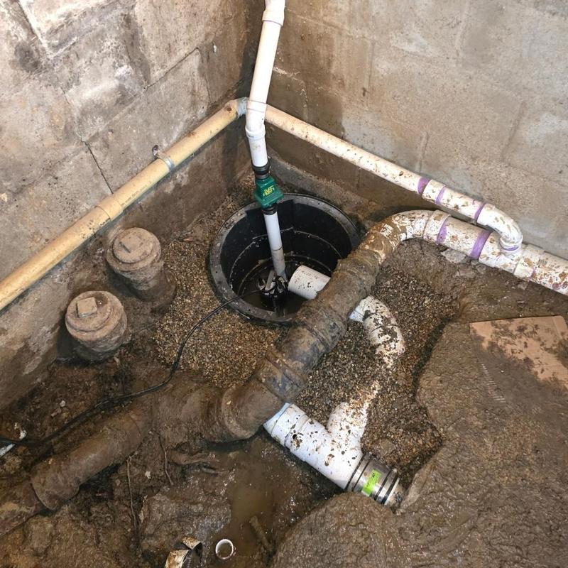Sump pump and pit installation with discharge piping