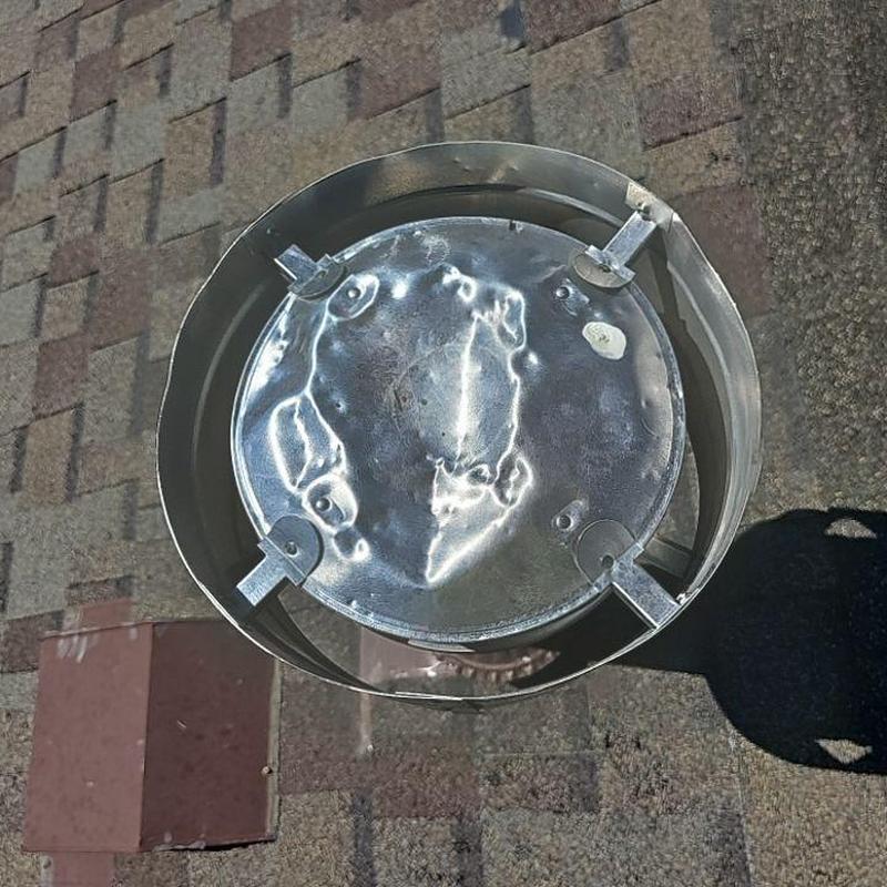 Metal roof vent cap with hail damage on shingles Metal roof vent cap with hail damage on shingles