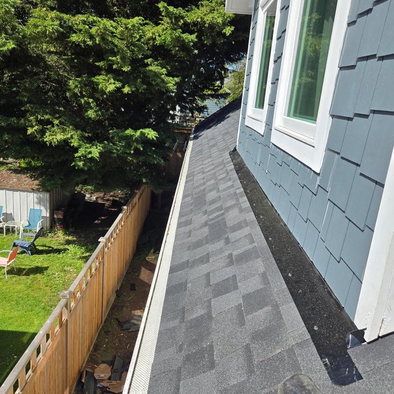 Asphalt shingle roof with gutter guard installation