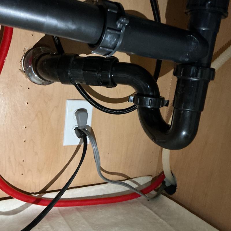 Kitchen sink drain pipes under cabinet with electrical outlet Kitchen sink drain pipes under cabinet with electrical outlet