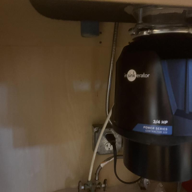Garbage disposal unit installed under kitchen sink