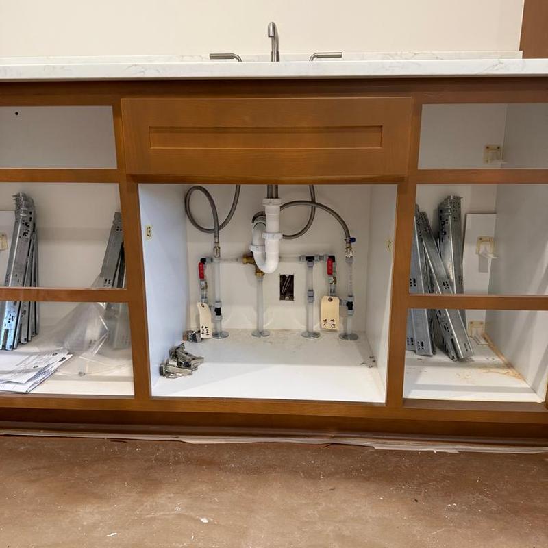 Bathroom sink plumbing and cabinet installation