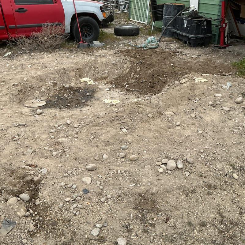 Septic tank excavation site with dirt and debris