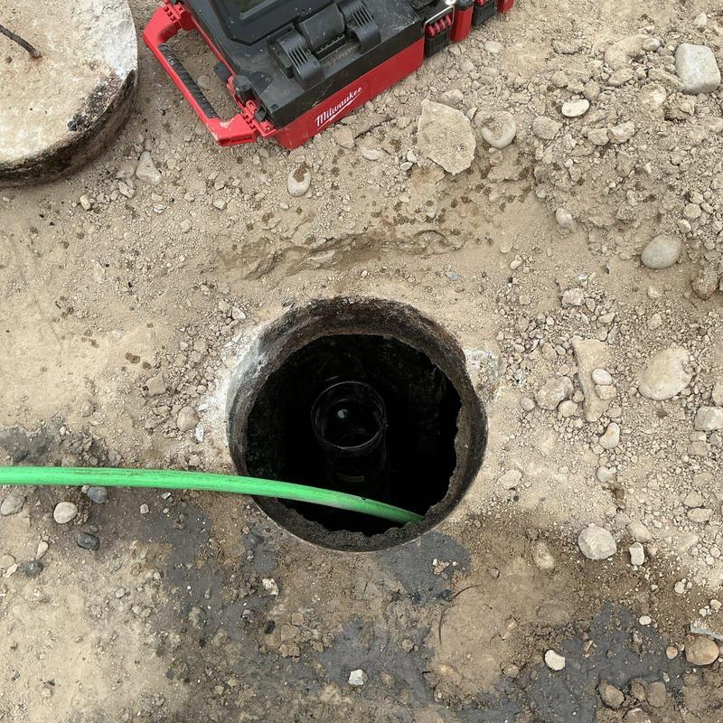Septic tank access hole with inspection camera hose