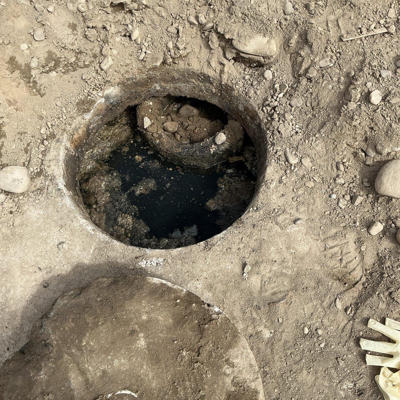 Septic tank open with concrete and dirt surrounding