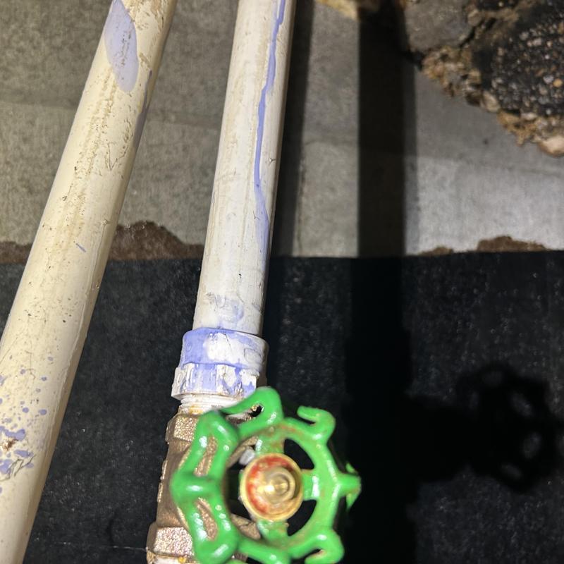 Gate valve and PVC piping with leak in crawlspace