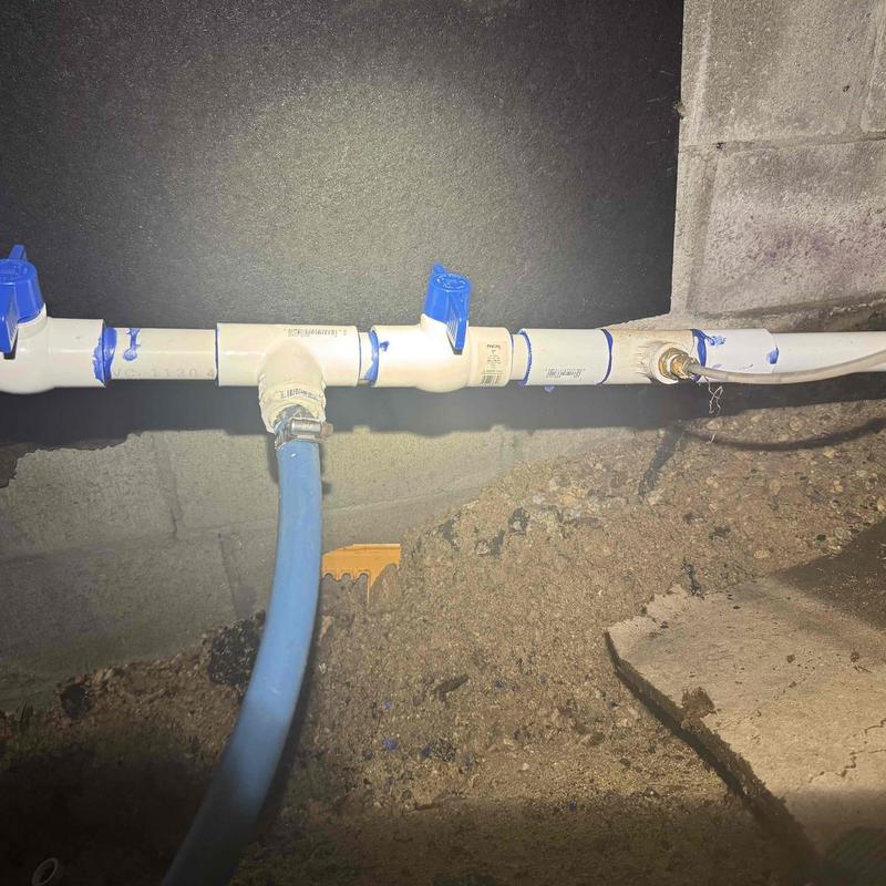 PVC gate valve with leaking cracked fitting in crawlspace