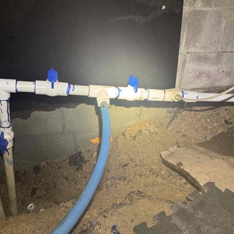 PVC piping with leaking gate valve in crawlspace