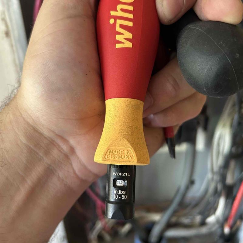 Torque wrench tightening electrical connections in panel