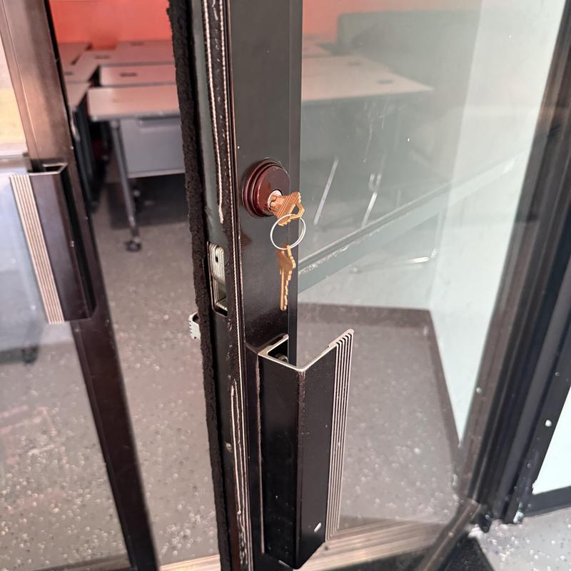 Storefront door lock with keys in cylinder
