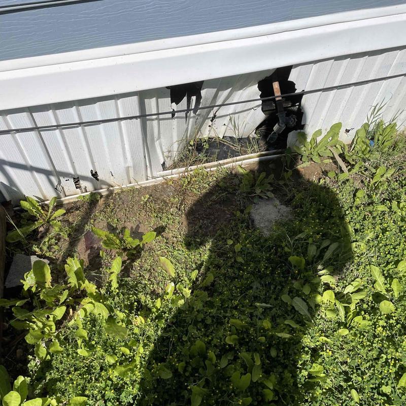 Galvanized pipe leak under mobile home siding