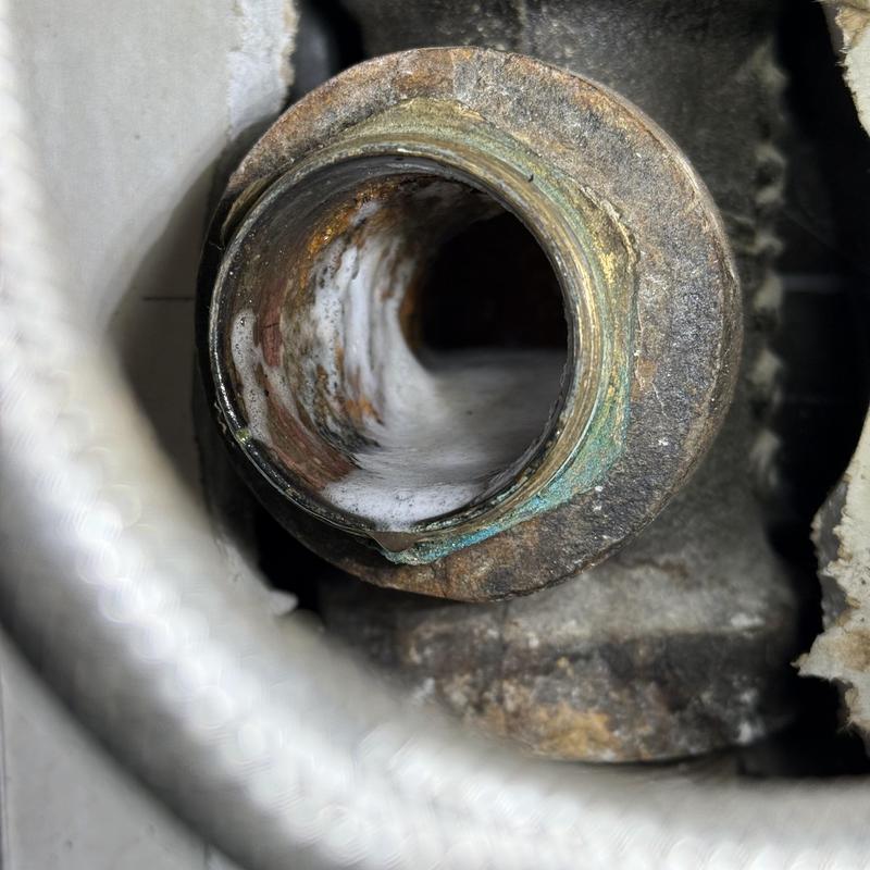 Kitchen sink drain pipe interior close-up with corrosion