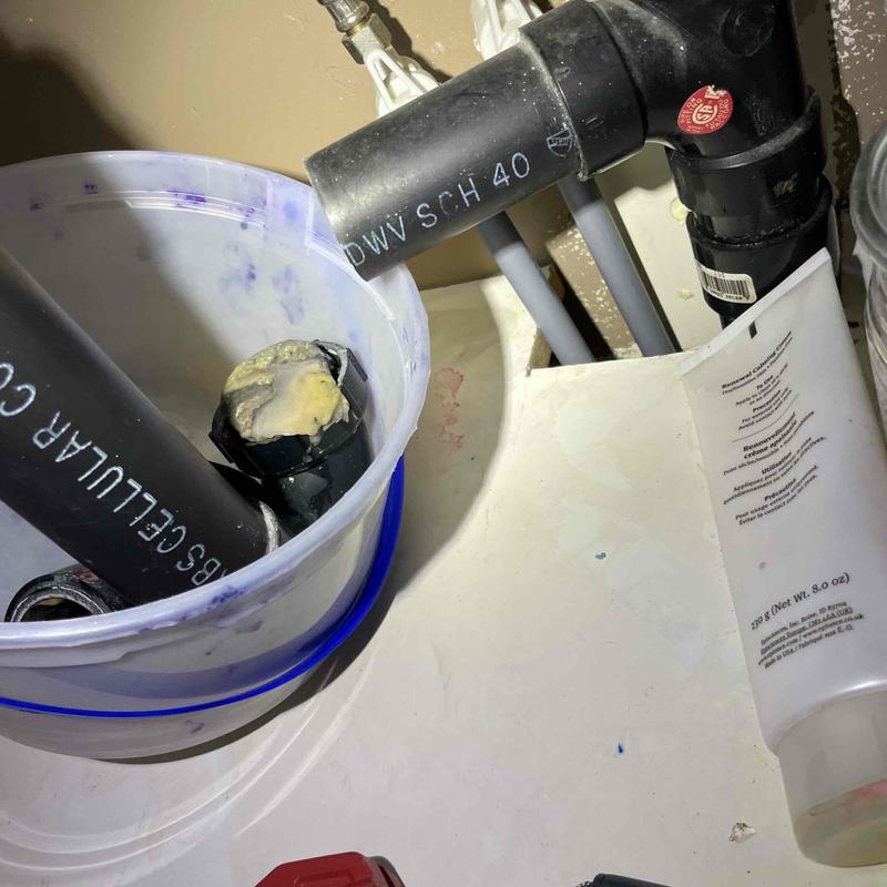 P-trap and drain pipes removed for clearing clog