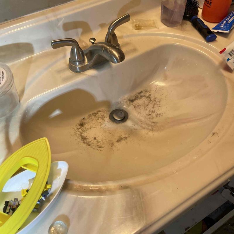 Bathroom sink drain with slow drainage and debris