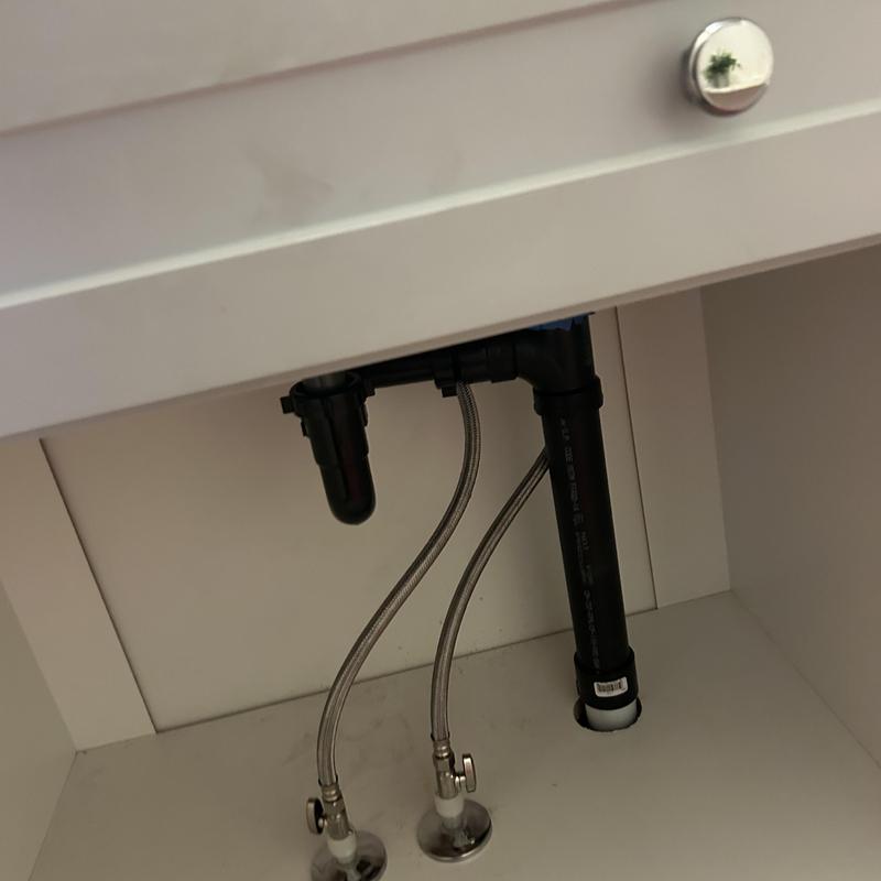 Sink supply lines and drain pipe installation under cabinet