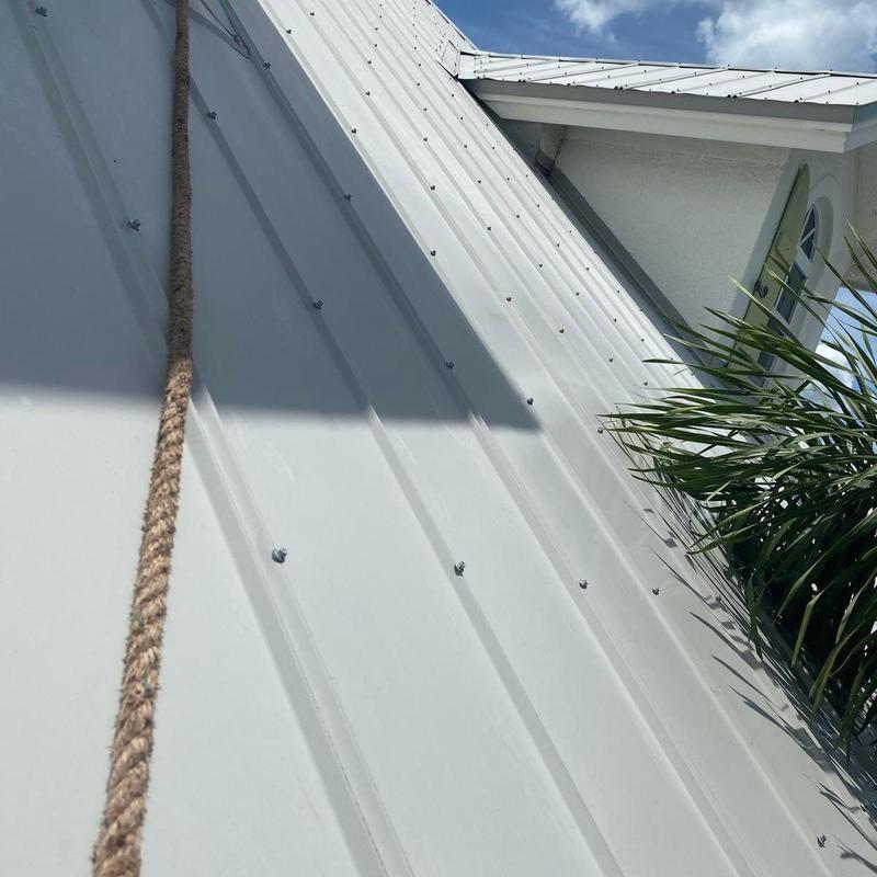 Standing seam metal roof with safety tieoff rope