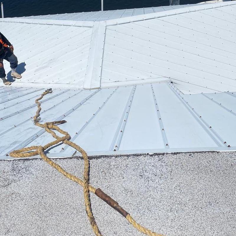 Standing seam metal roof with safety tieoff rope