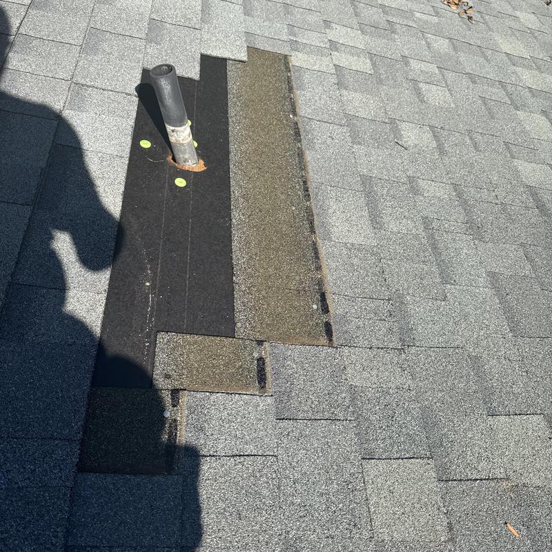 Pipe boot with new flashing and asphalt shingles on roof