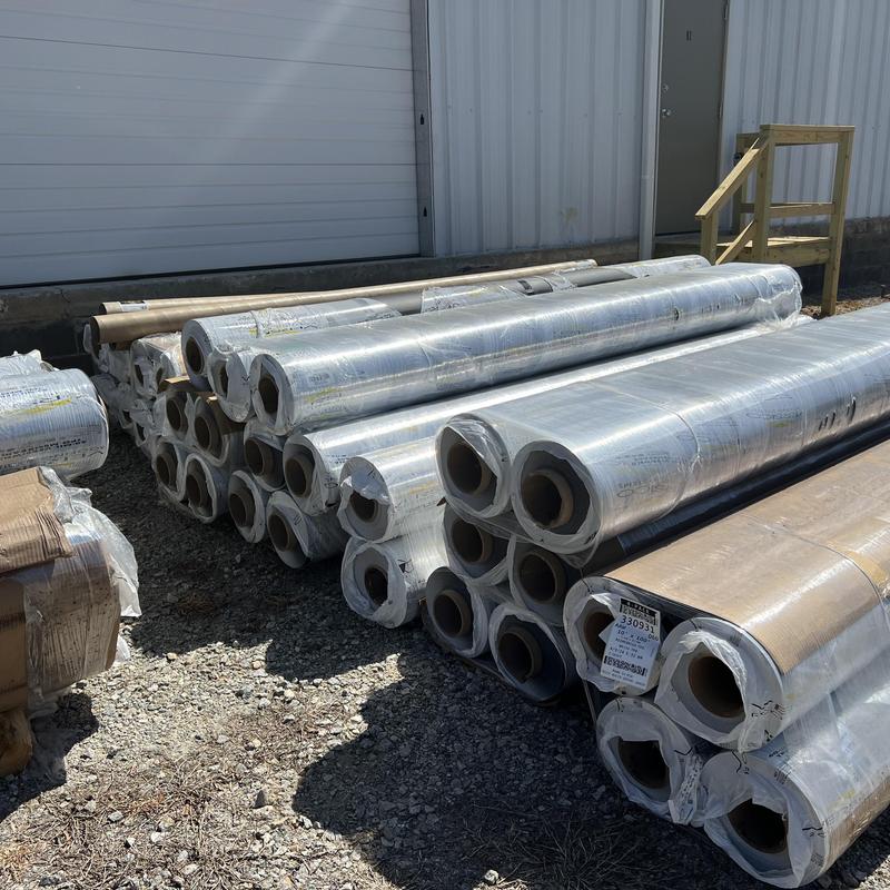 Versico 60 mil TPO roofing membrane rolls stacked outdoors
