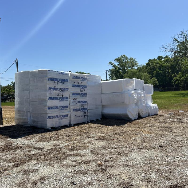 Insulation foam sheets stacked outdoors on ground