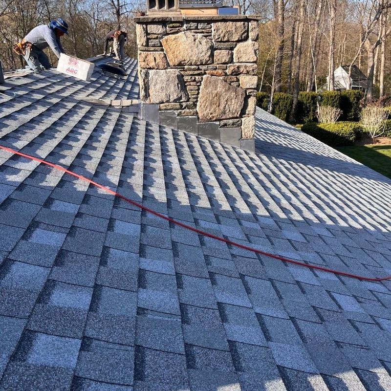 Asphalt shingle roof with chimney flashing installation
