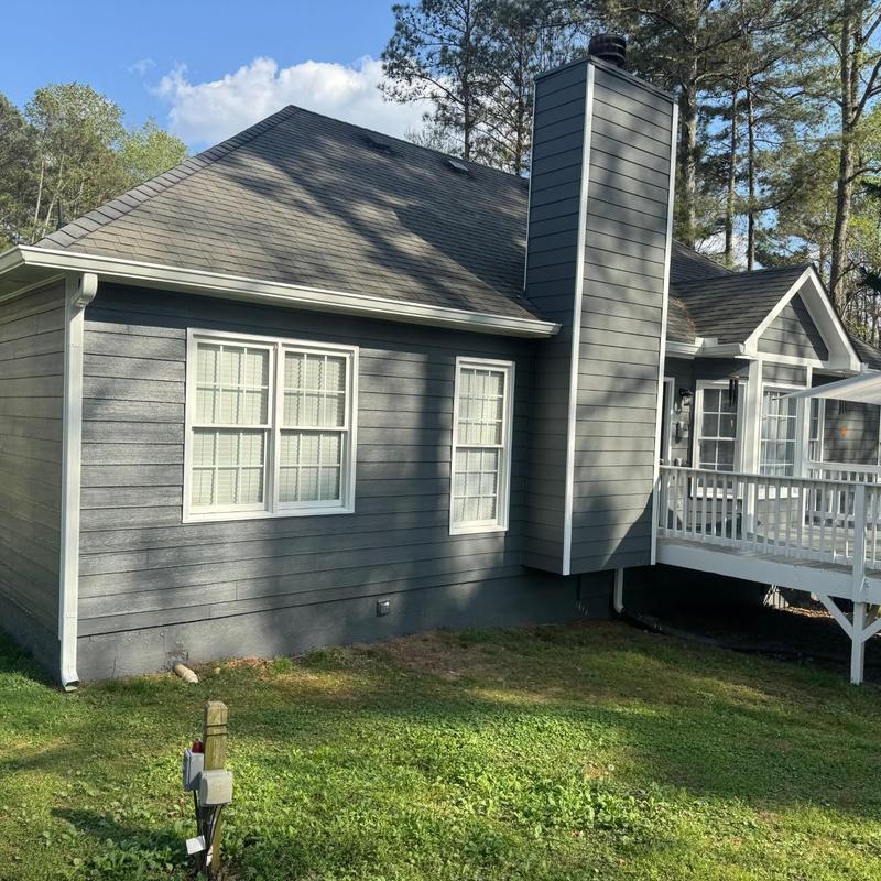 Asphalt shingle roof on residential house with chimney