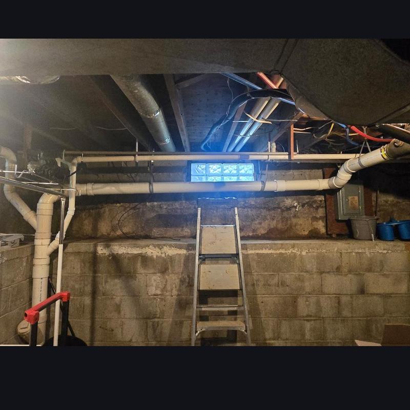 Cast iron pipe replacement in basement with ladder