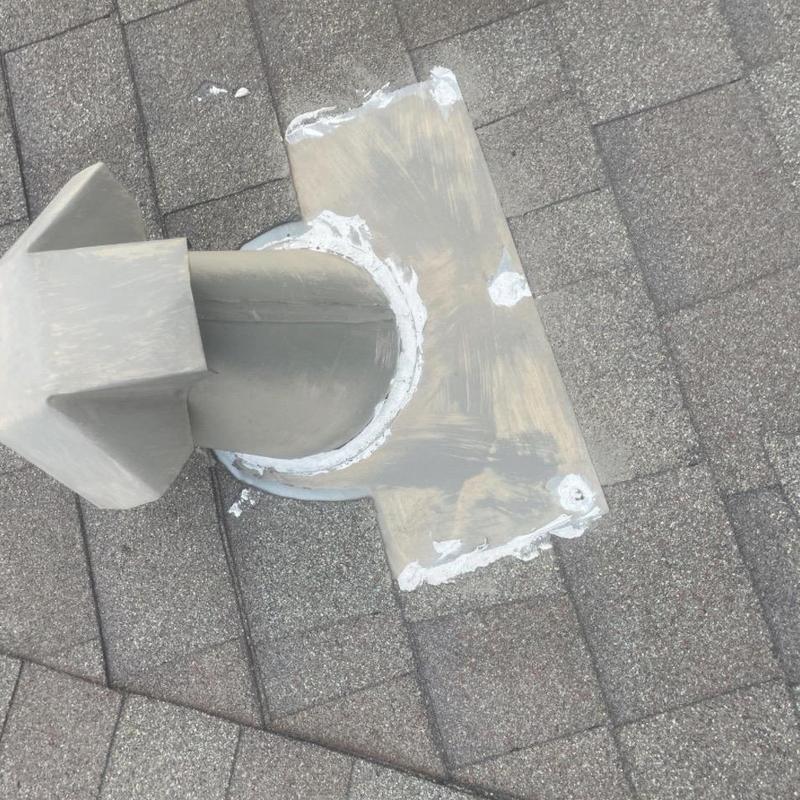 Pipe boot flashing on shingle roof with sealant applied