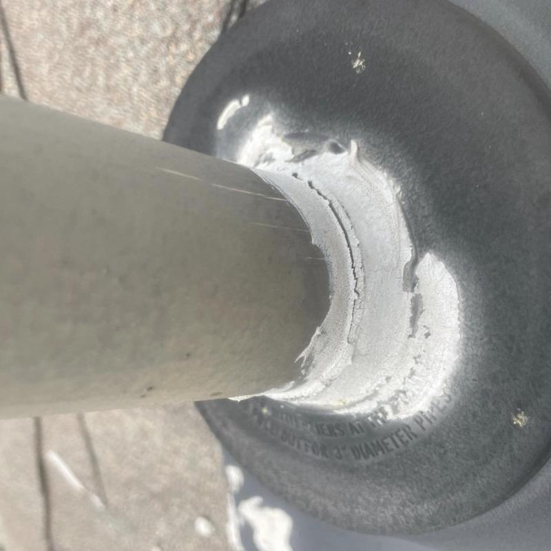 Pipe boot roofing flashing with sealant on pipe