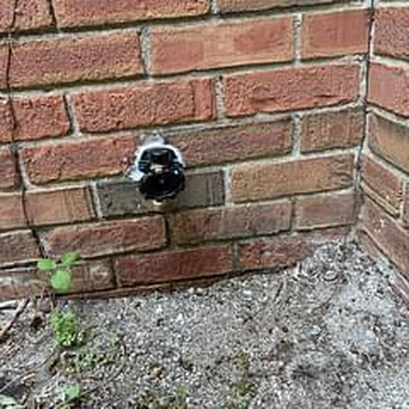 Hose bib installation on brick exterior wall