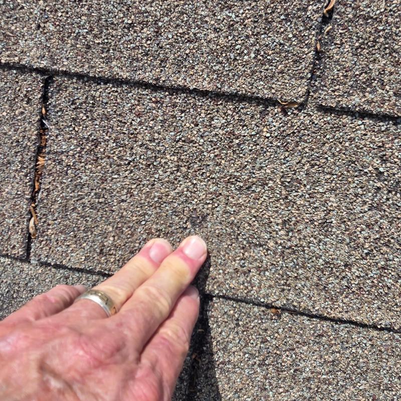 Asphalt roof shingles with hail damage close-up