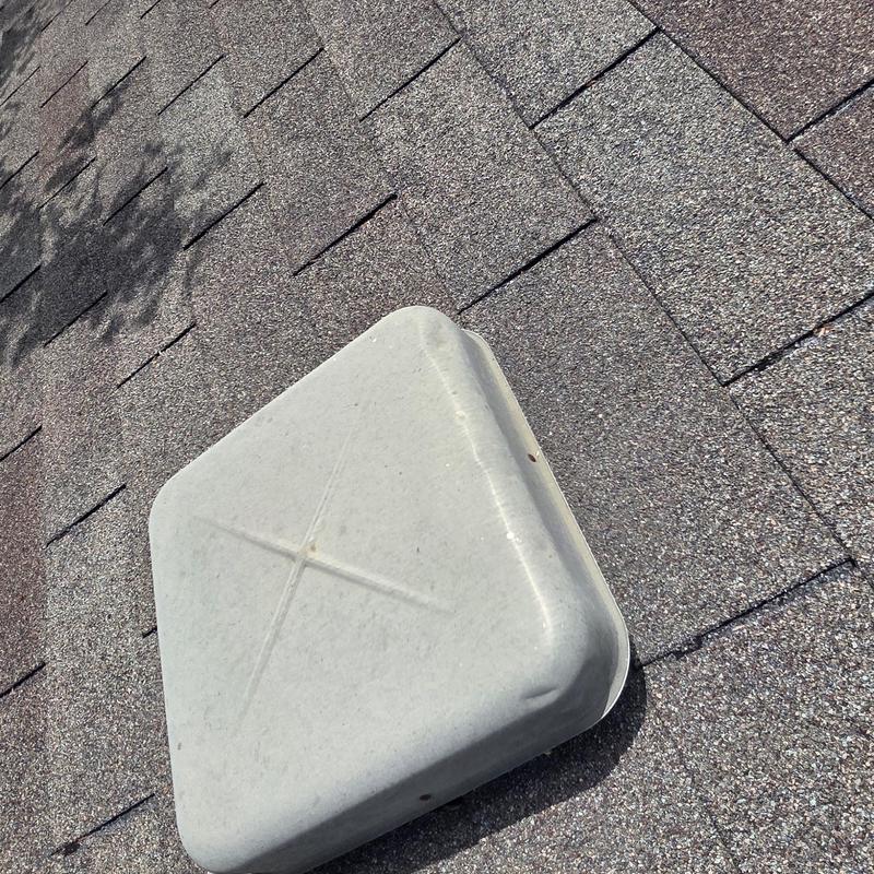 Roof vent with hail damage on asphalt shingles
