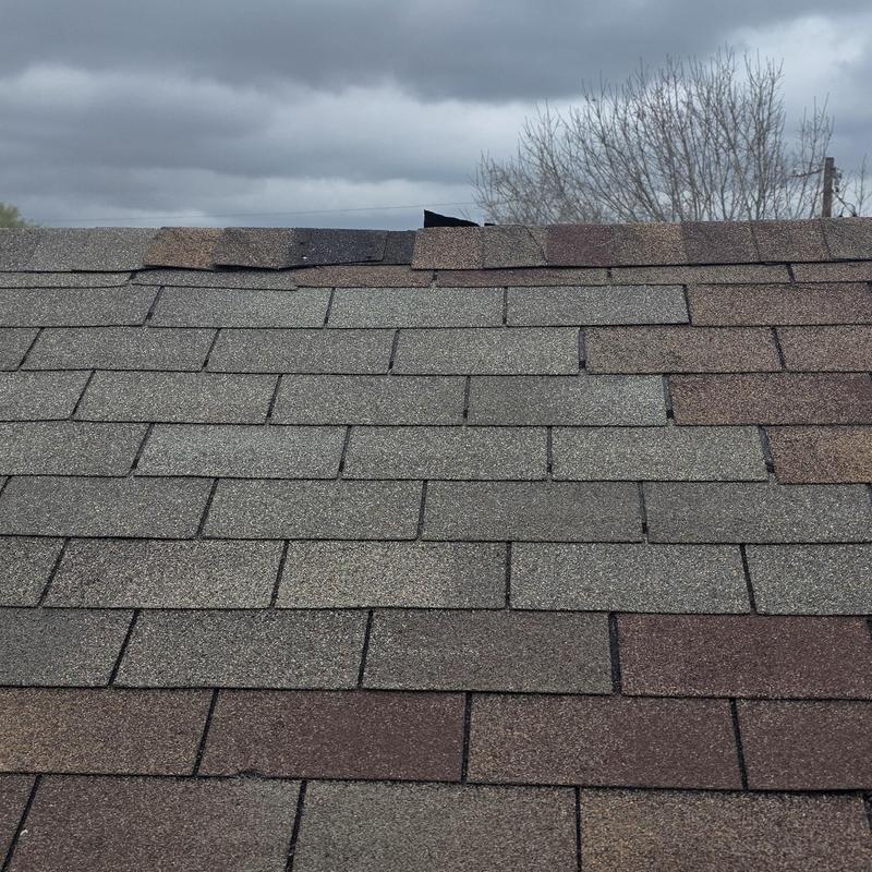 Asphalt shingles roof with new shingle patches