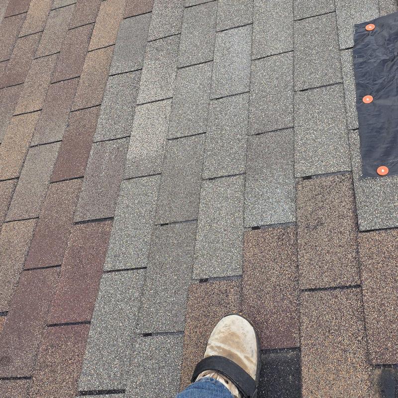 Asphalt shingle roof with new replacement sections