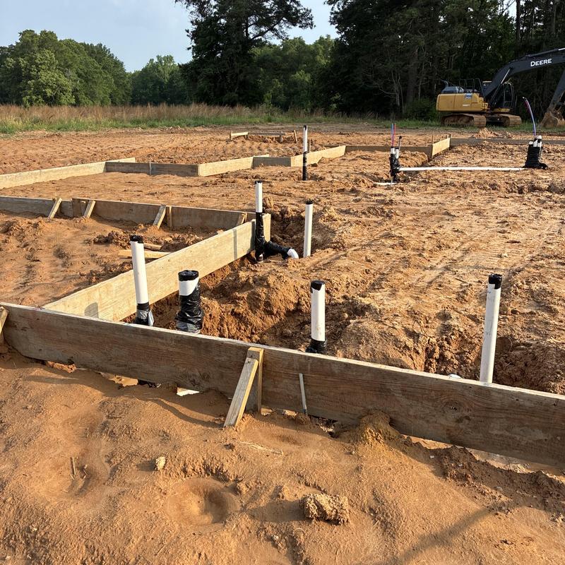 PVC plumbing rough-in and water line installation site