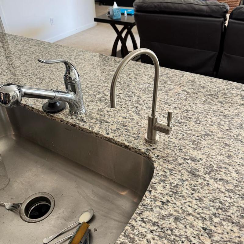 Reverse osmosis faucet installed on granite countertop