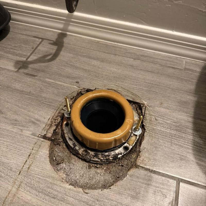 Toilet flange replacement on tiled bathroom floor