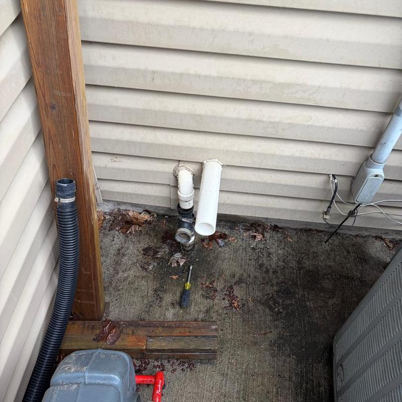 Backup sump pump discharge pipe installation outdoors