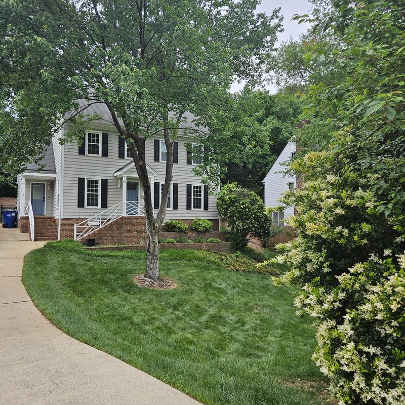 Attic bedroom conversion exterior with siding and landscaping