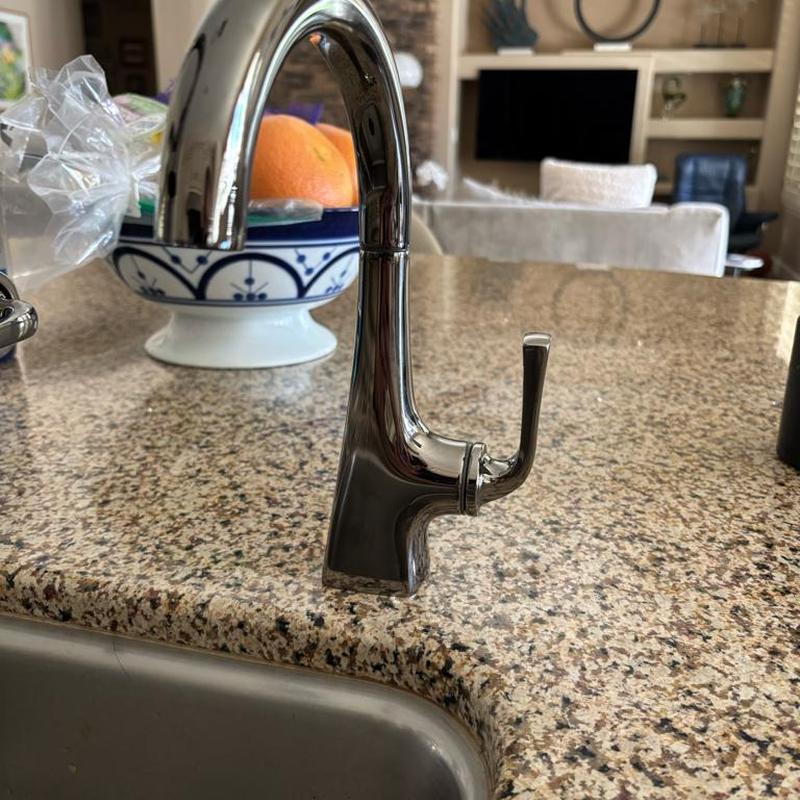 Kitchen sink faucet with single lever handle on granite counter