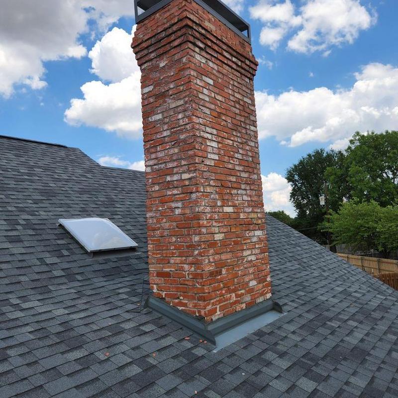 Brick chimney mortar repair and sealing on roof