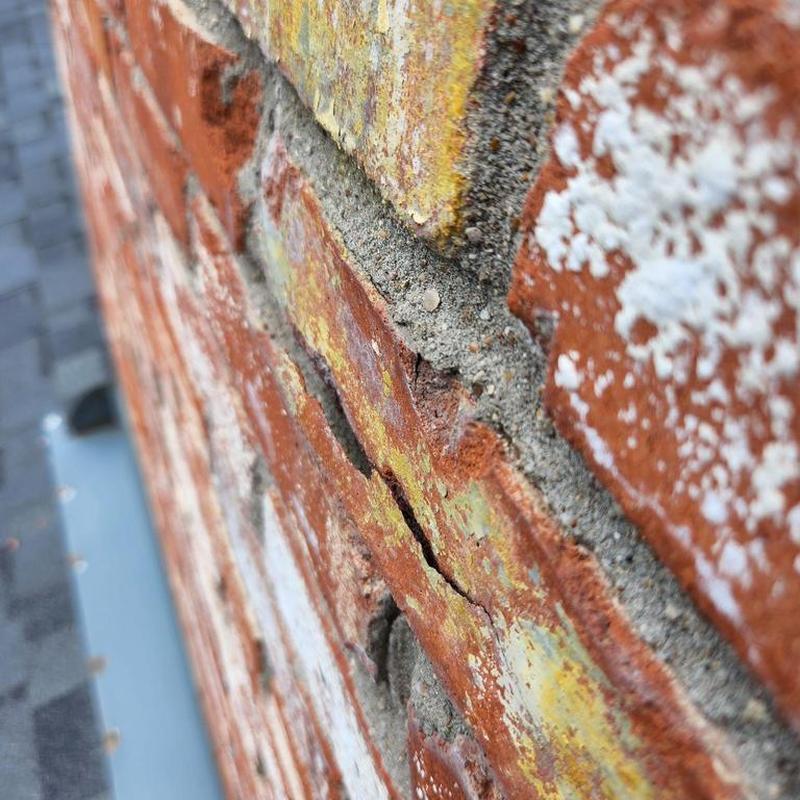 Chimney brick with cracked mortar close-up detail