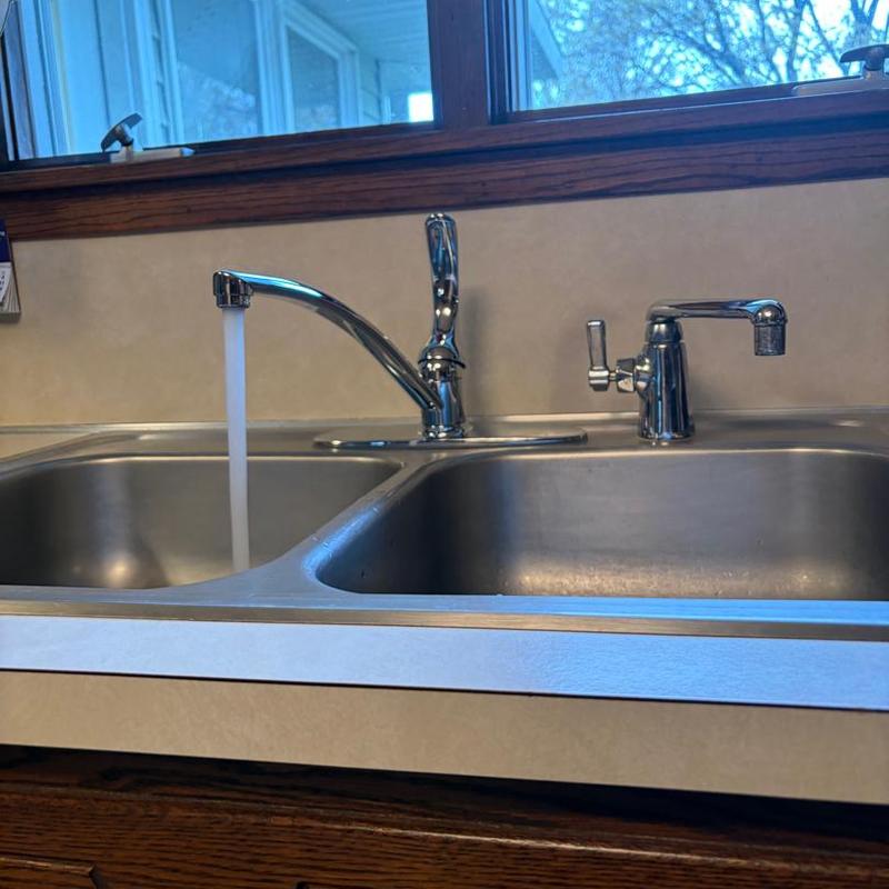 Kitchen faucet with running water in double sink