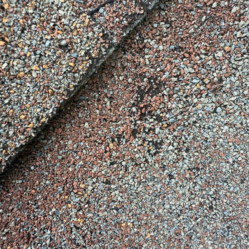 Asphalt shingles with hail damage granules close-up