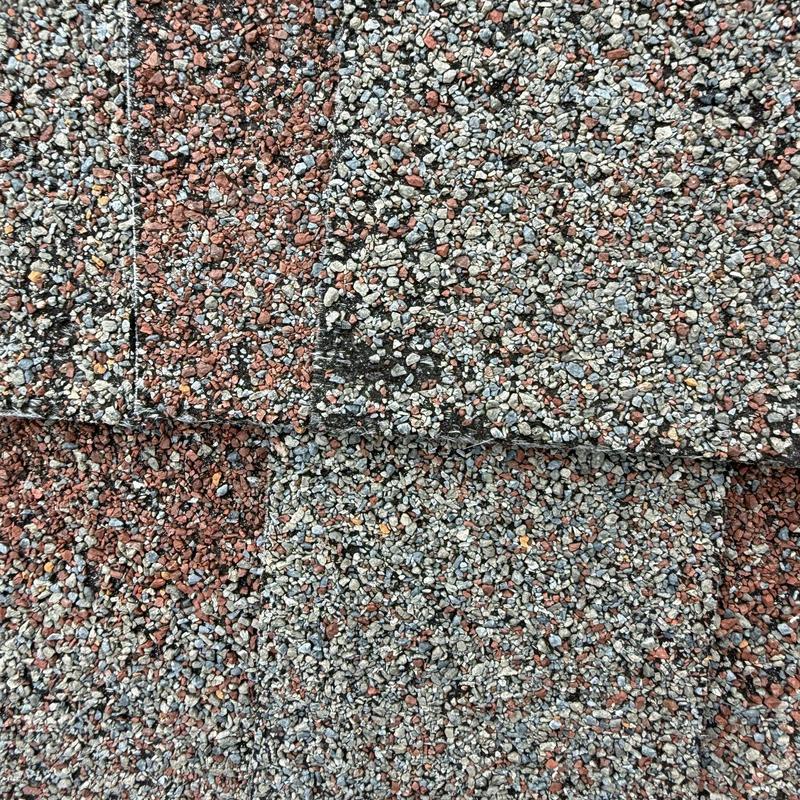 Asphalt roof shingles with hail damage close-up